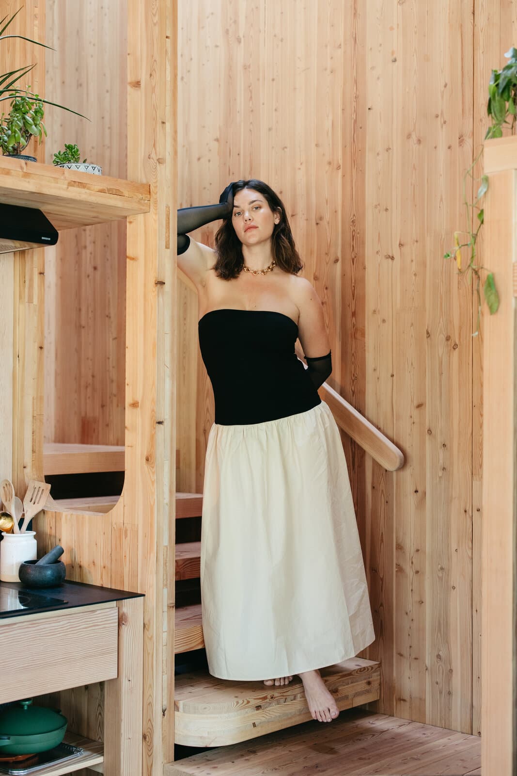 Ali Tate Cutler in a black bustier on pine stairs