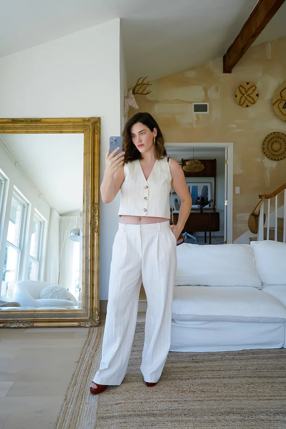 Ali Tate Cutler in an ivory pinstripe suit, editorial portrait